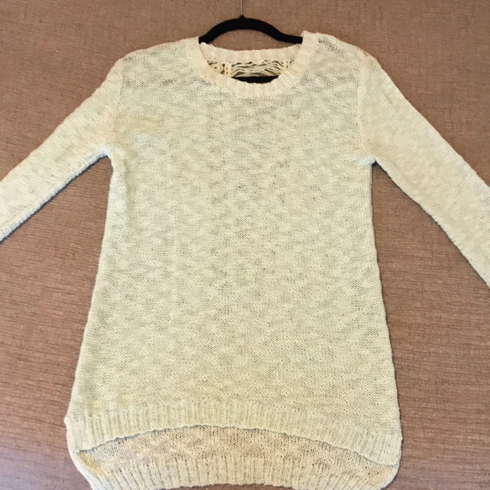 Teal poof sweater with open design in back